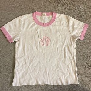 John Galt baby tee. White and pink. Embroidered baby devil.
